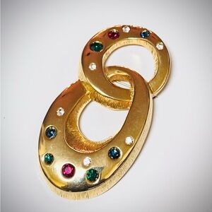 Elegant Les Bernard Gold-Tone Linked Brooch with Multicolor Gems